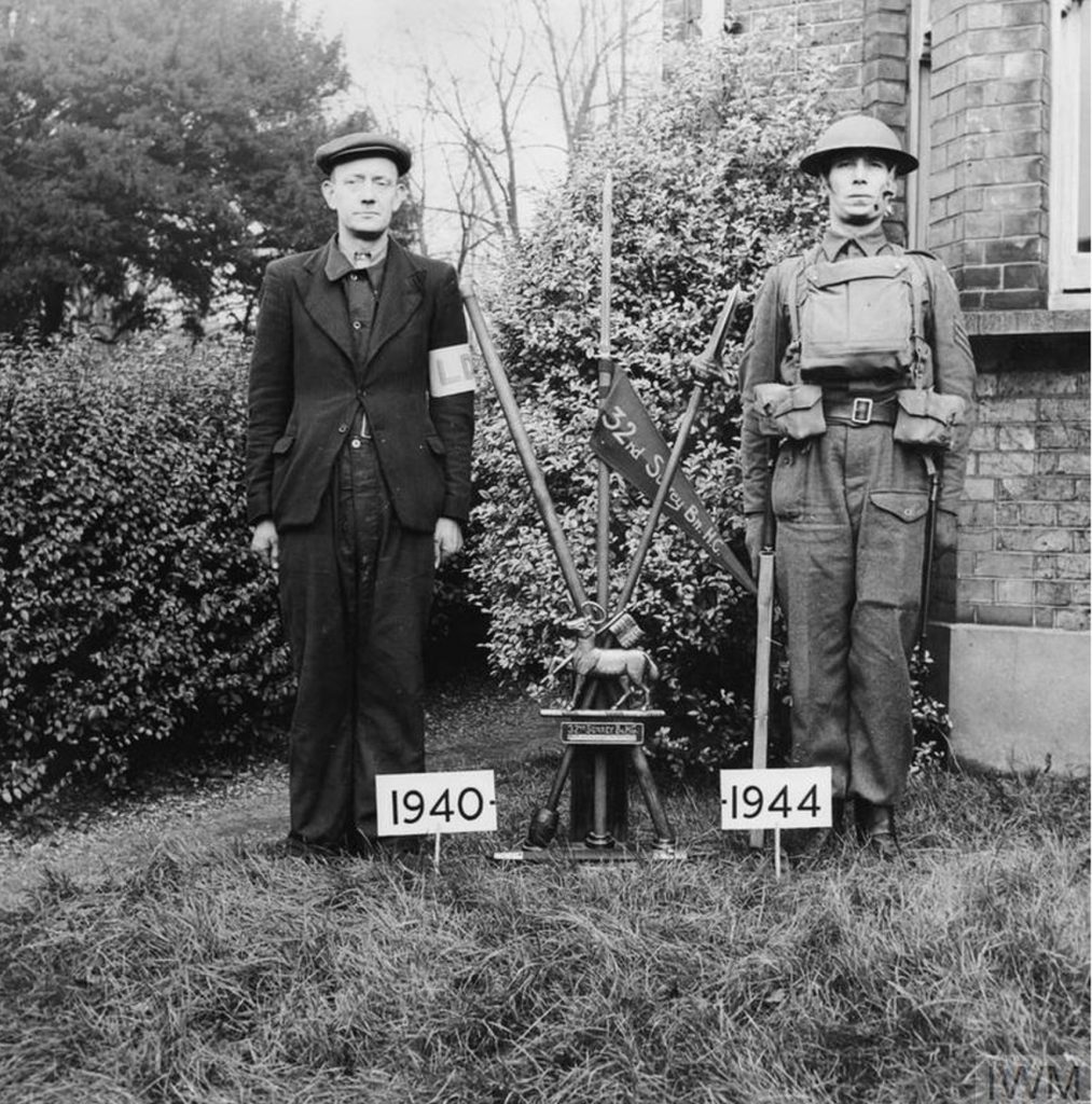 This photograph clearly shows the contrast between a 1940 Local Defence Volunteer and a member of the Home Guard in 1944.